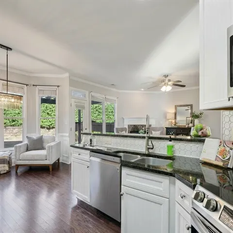 a kitchen with white cabinets and appliances