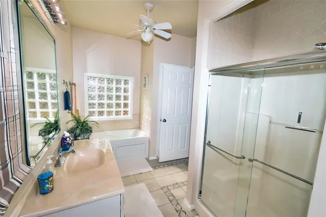 a very nice looking room with a glass door shower and a bathtub