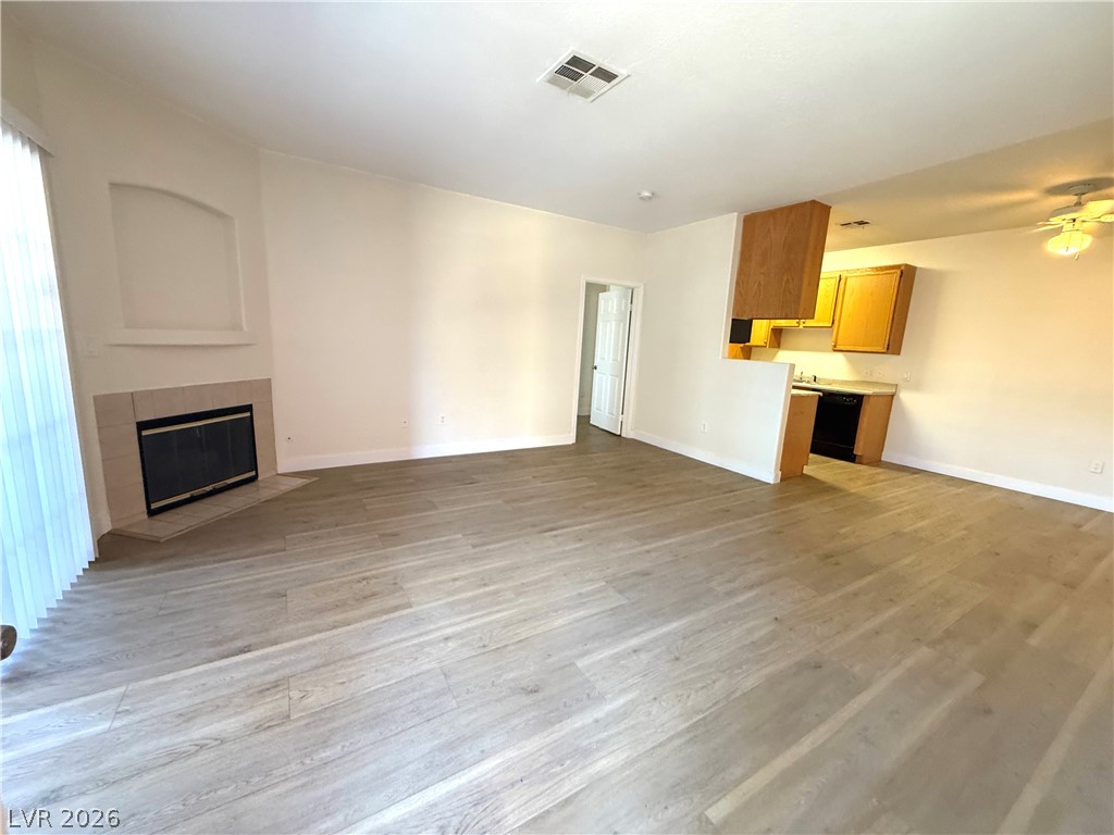 4730 East Craig Road, Unit 1164 Las Vegas, NV 89115 - Photo 1 of 14 A contemporary open-concept layout unites living space with kitchen, offering modern flooring and a fireplace.