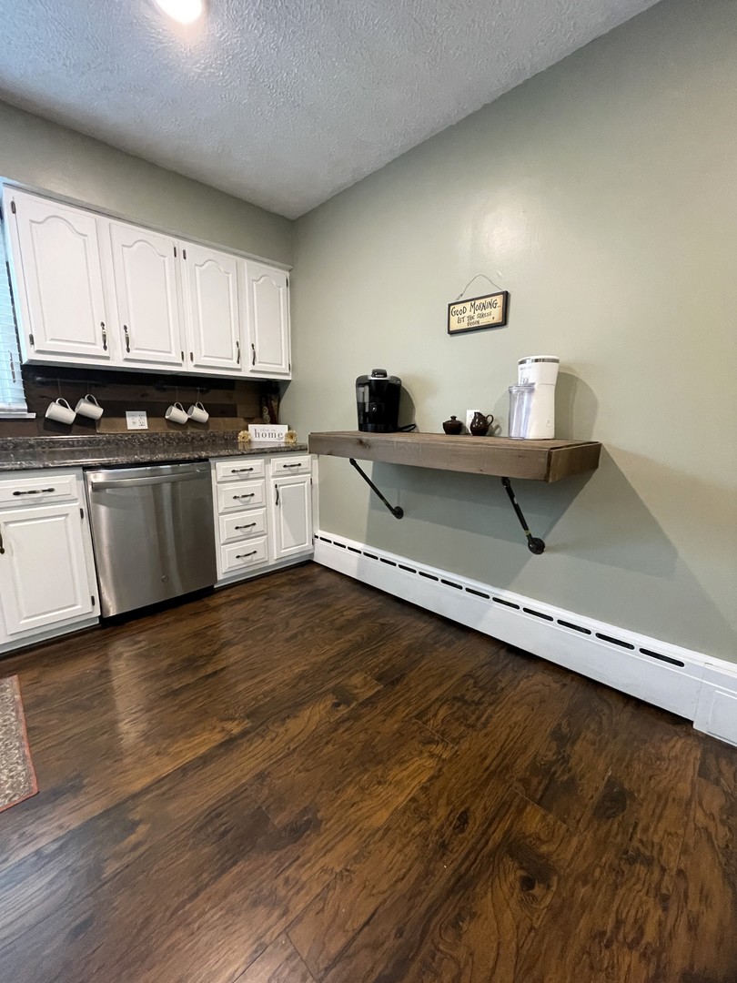 1608 Chevy Chase Drive Champaign, IL 61821 - Photo 17 of 53 a kitchen with wooden floors and white appliances