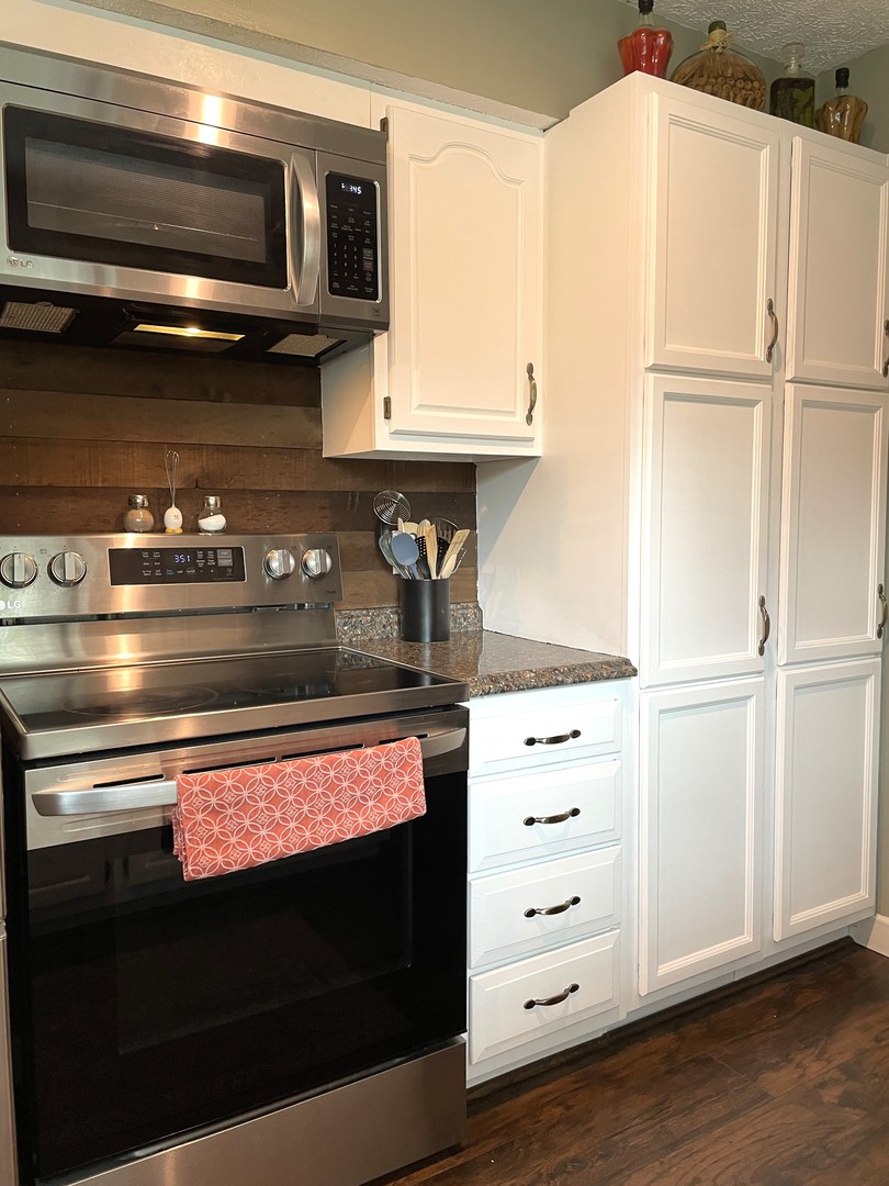 1608 Chevy Chase Drive Champaign, IL 61821 - Photo 21 of 53 a kitchen with stainless steel appliances and white cabinets