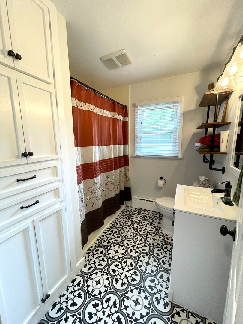 1608 Chevy Chase Drive Champaign, IL 61821 - Photo 29 of 53 a bathroom with a sink a toilet and shower