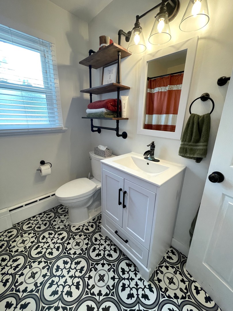 1608 Chevy Chase Drive Champaign, IL 61821 - Photo 30 of 53 a bathroom with a sink a toilet and mirror