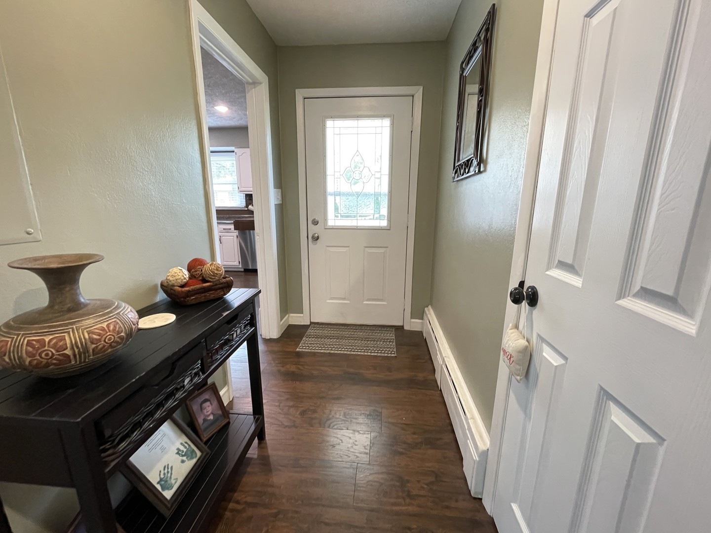 1608 Chevy Chase Drive Champaign, IL 61821 - Photo 5 of 53 a view of a hallway to a livingroom with wooden floor and furniture