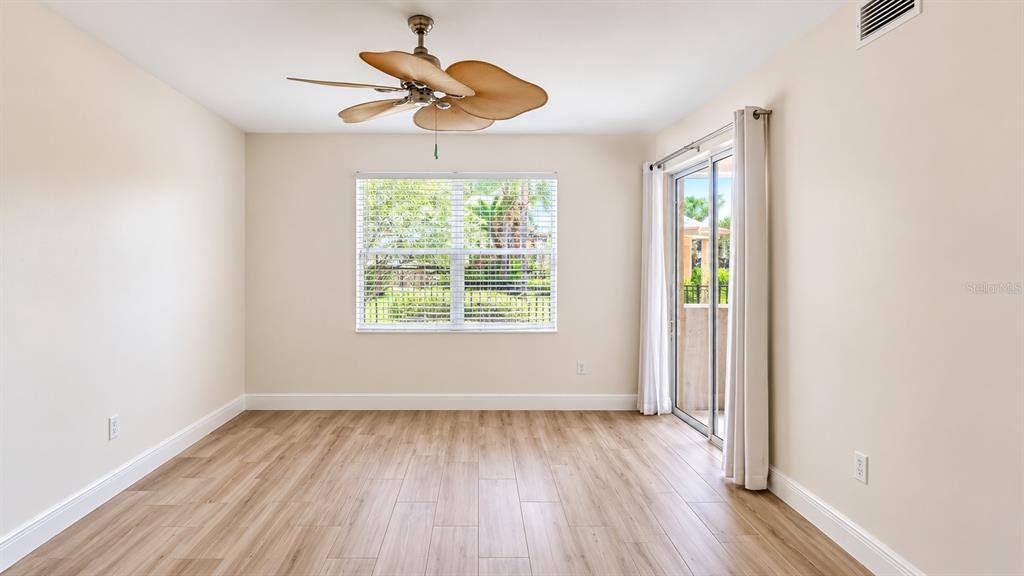 6552 Moorings Point Circle, Unit 102 Lakewood Ranch, FL 34202 - Photo 16 of 57 wooden floor in an empty room with a window