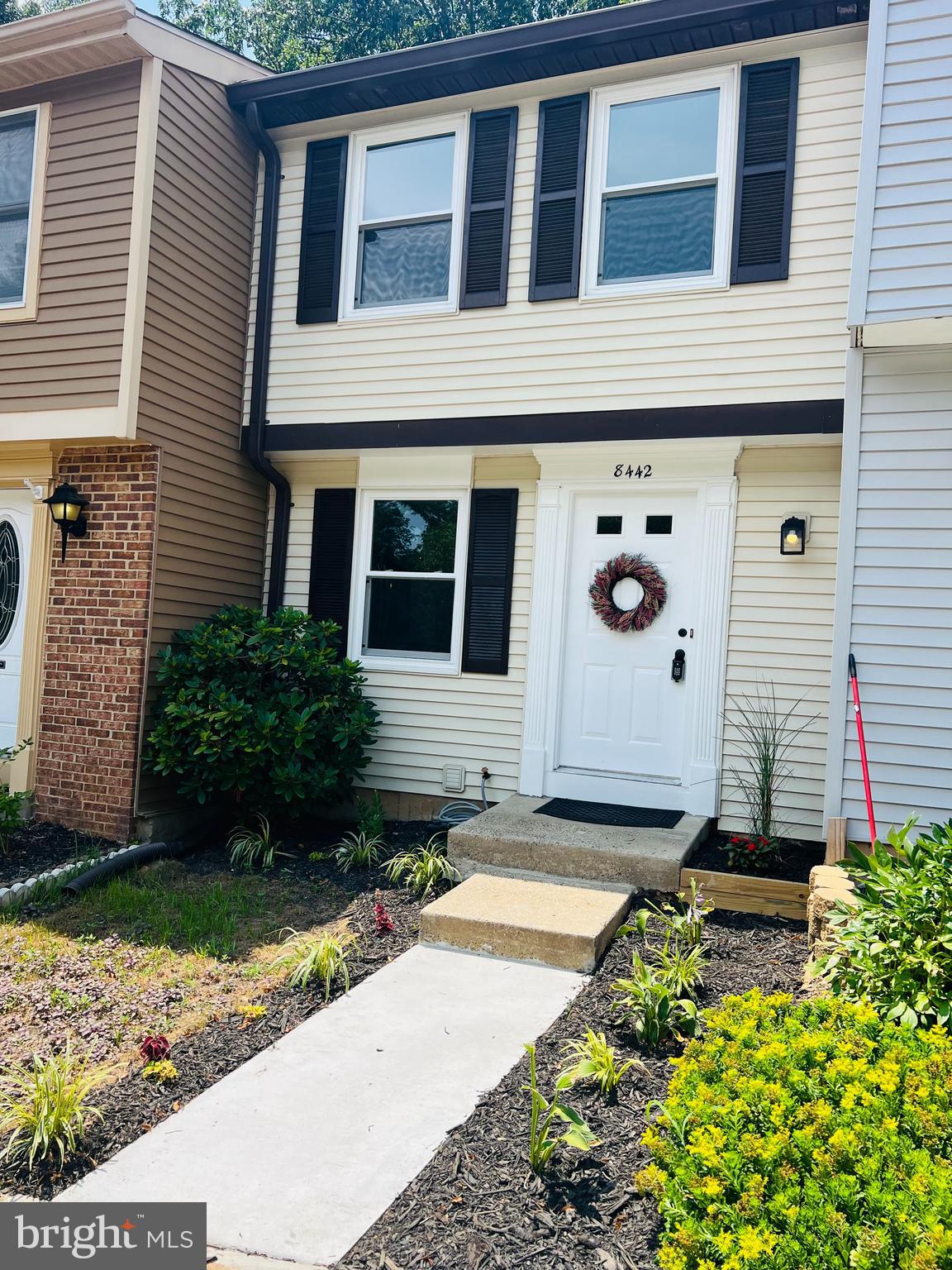 a front view of a house with garden