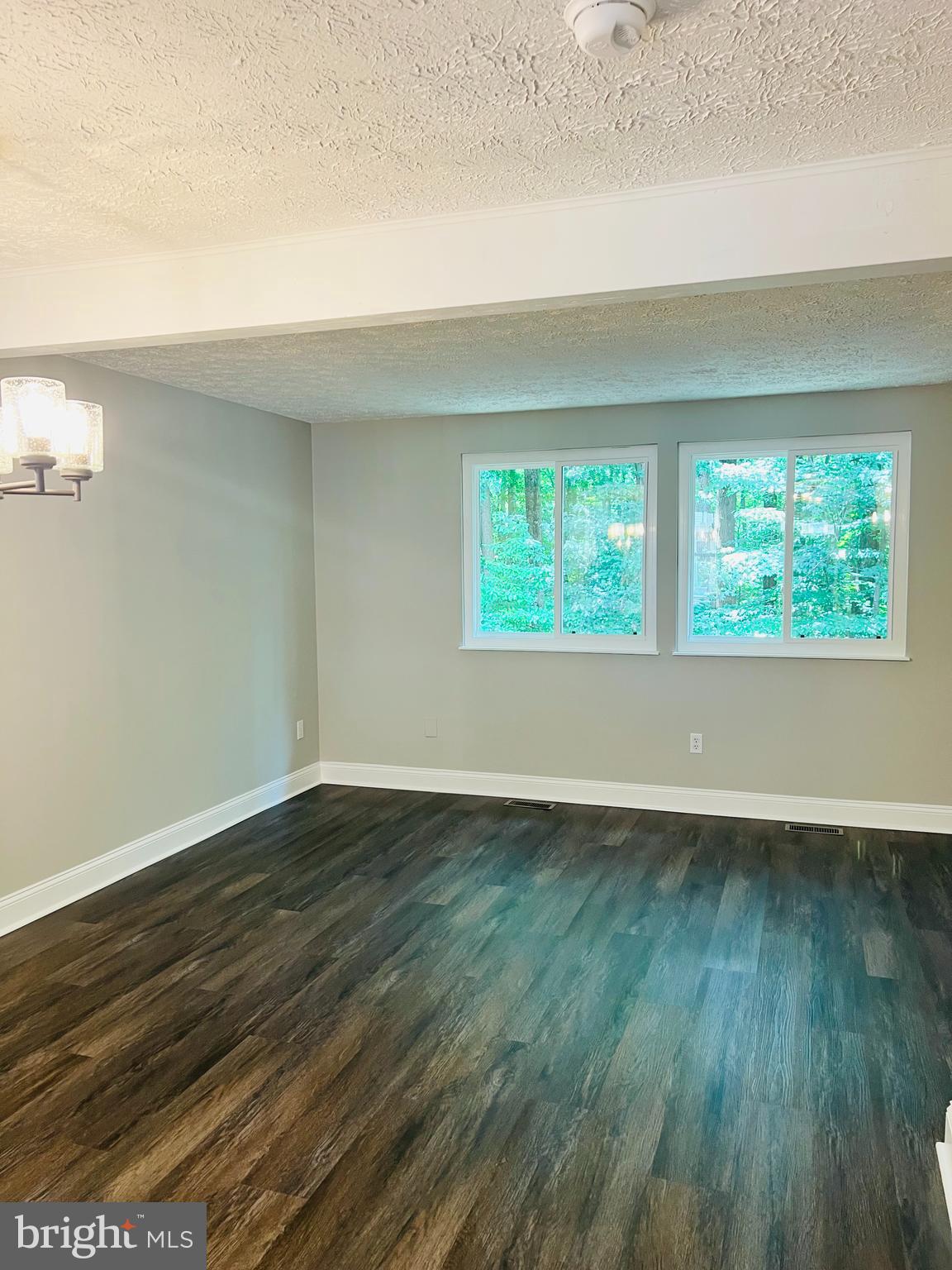 8442 Sugar Creek Lane Springfield, VA 22153 - Photo 11 of 39 an empty room with wooden floor and windows