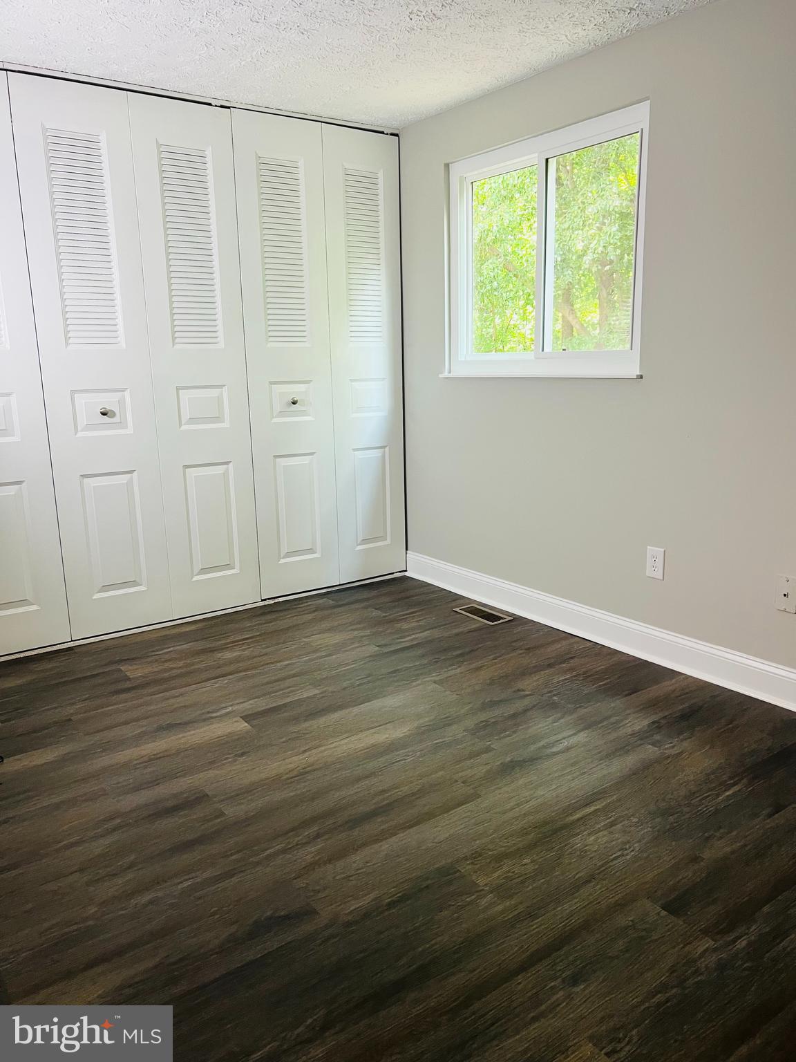 8442 Sugar Creek Lane Springfield, VA 22153 - Photo 12 of 39 an empty room with wooden floor and windows