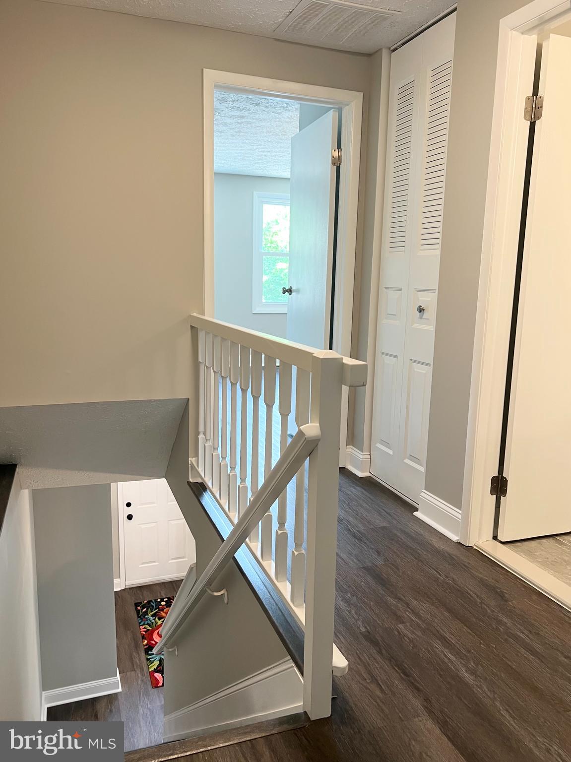 8442 Sugar Creek Lane Springfield, VA 22153 - Photo 15 of 39 a view of a hallway with wooden floor and staircase