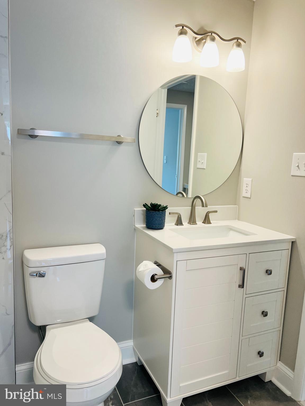 8442 Sugar Creek Lane Springfield, VA 22153 - Photo 16 of 39 a bathroom with a toilet sink and mirror