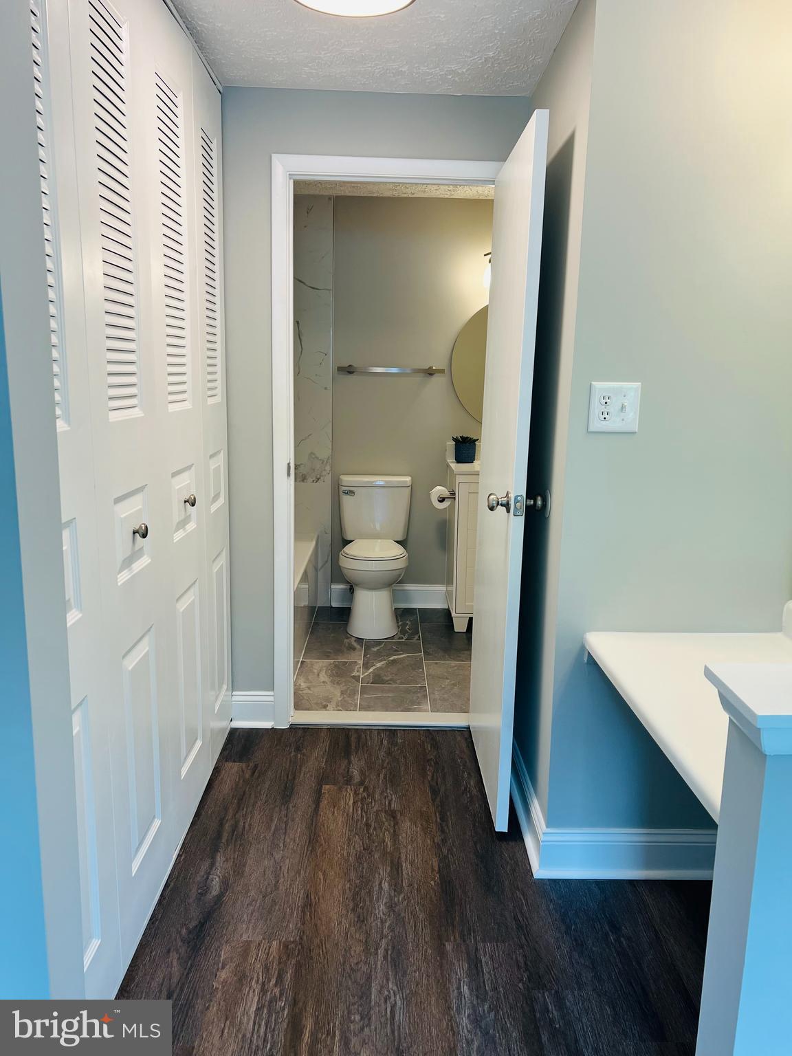 8442 Sugar Creek Lane Springfield, VA 22153 - Photo 19 of 39 a view of a hallway with wooden floor and a bathroom