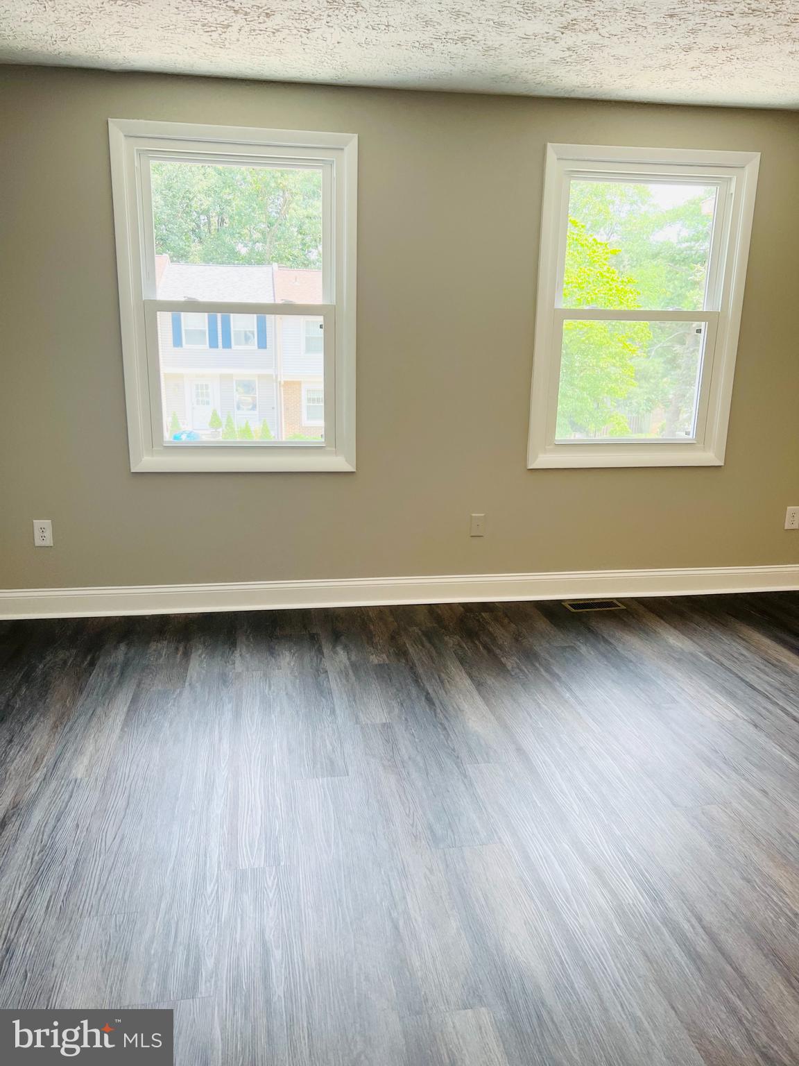 8442 Sugar Creek Lane Springfield, VA 22153 - Photo 23 of 39 an empty room with wooden floor and windows