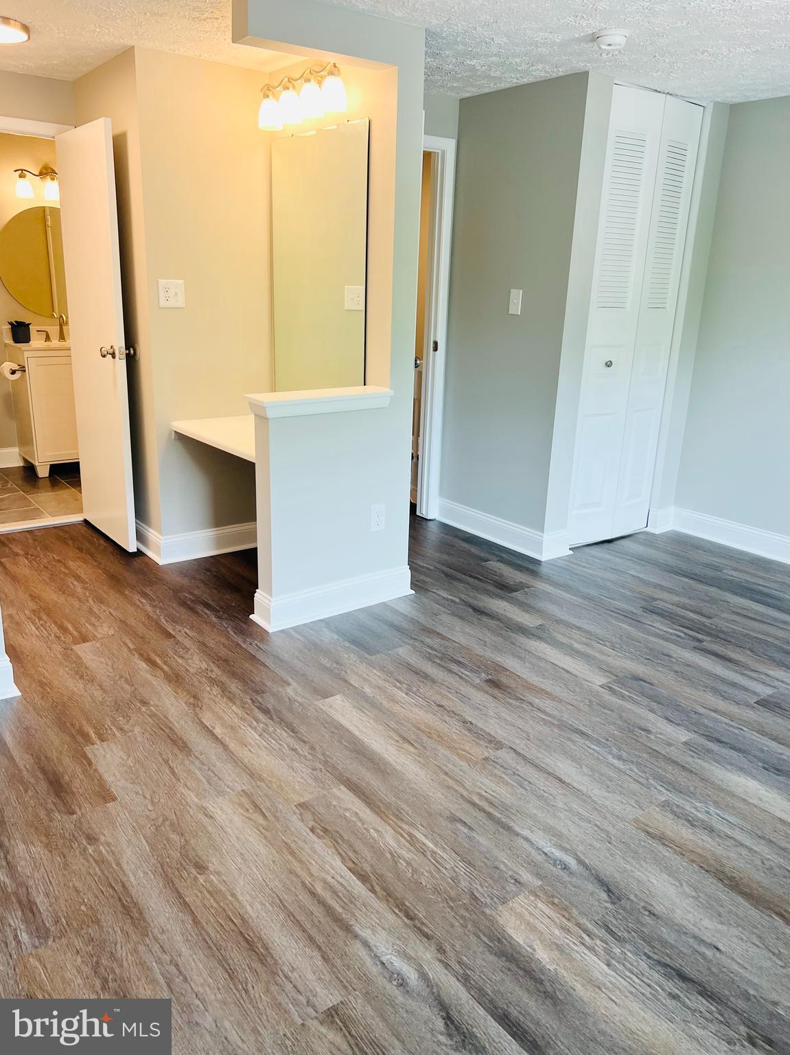 8442 Sugar Creek Lane Springfield, VA 22153 - Photo 24 of 39 an empty room with wooden floor and windows