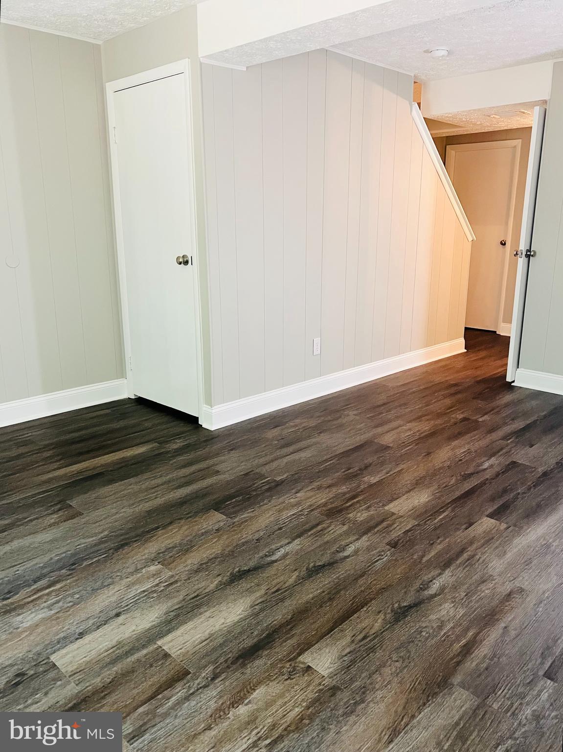 8442 Sugar Creek Lane Springfield, VA 22153 - Photo 25 of 39 a view of an empty room with wooden floor and stairs