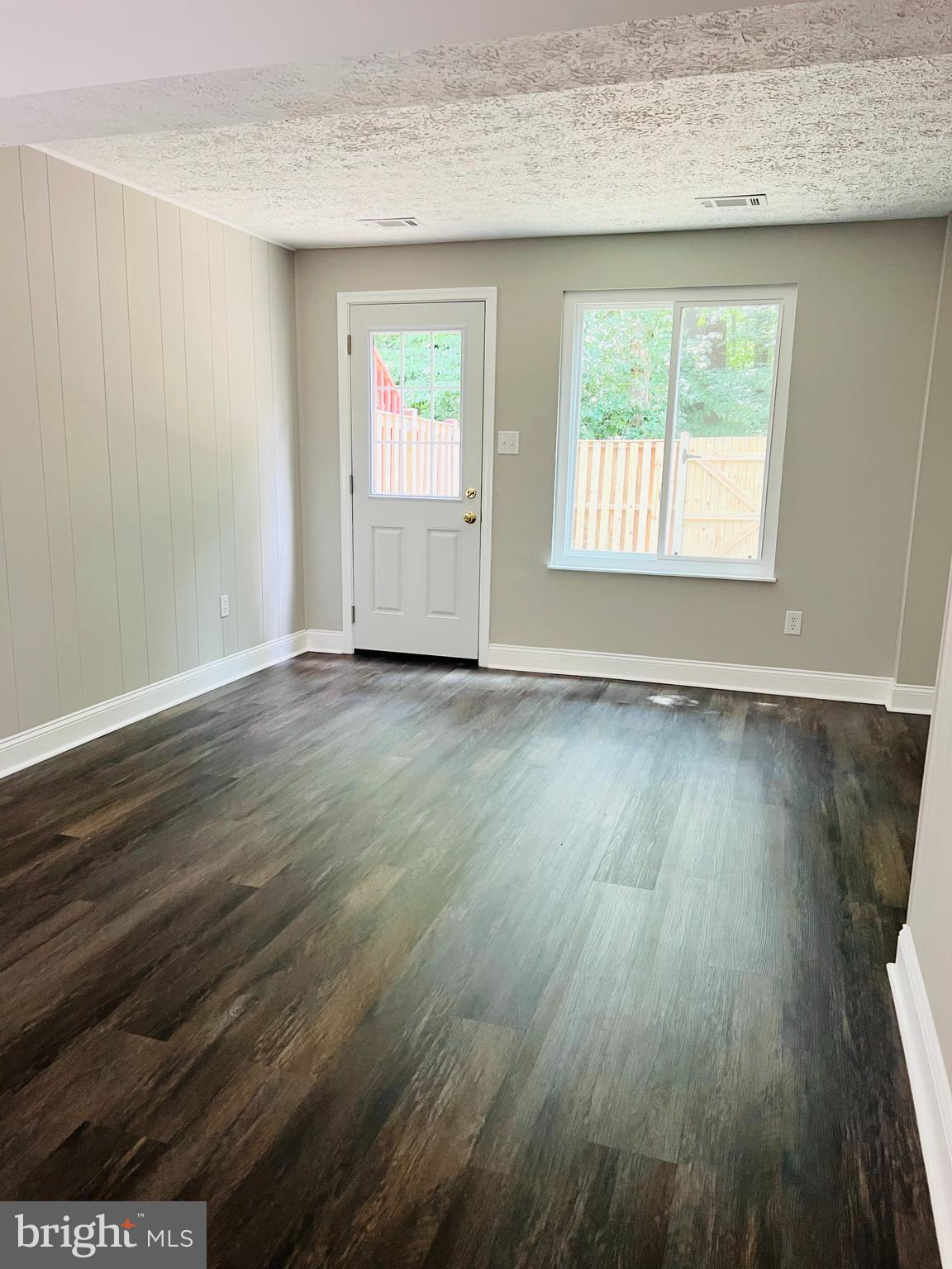 8442 Sugar Creek Lane Springfield, VA 22153 - Photo 26 of 39 an empty room with wooden floor and windows