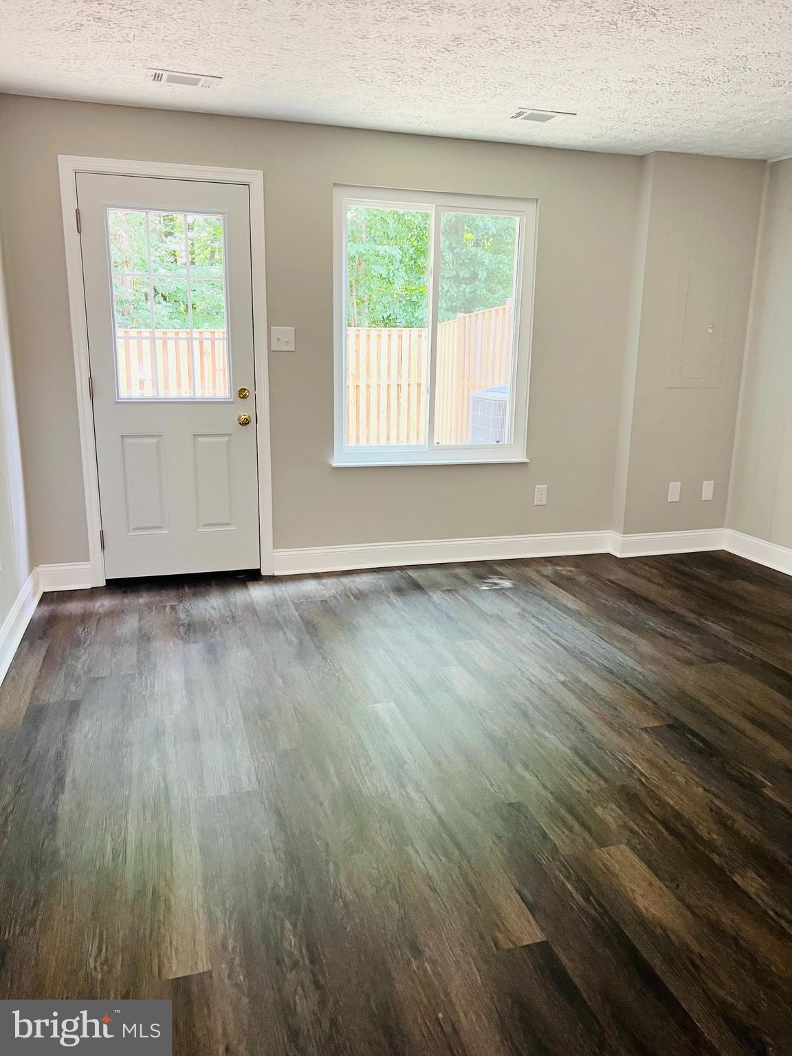 8442 Sugar Creek Lane Springfield, VA 22153 - Photo 27 of 39 an empty room with wooden floor and windows