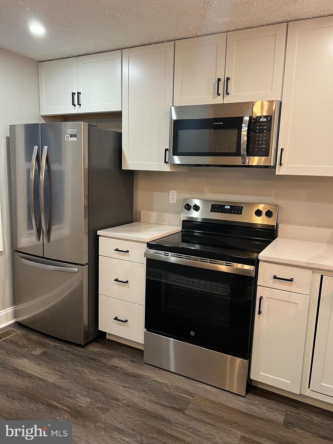 8442 Sugar Creek Lane Springfield, VA 22153 - Photo 4 of 39 a kitchen with stainless steel appliances a stove a microwave and a refrigerator