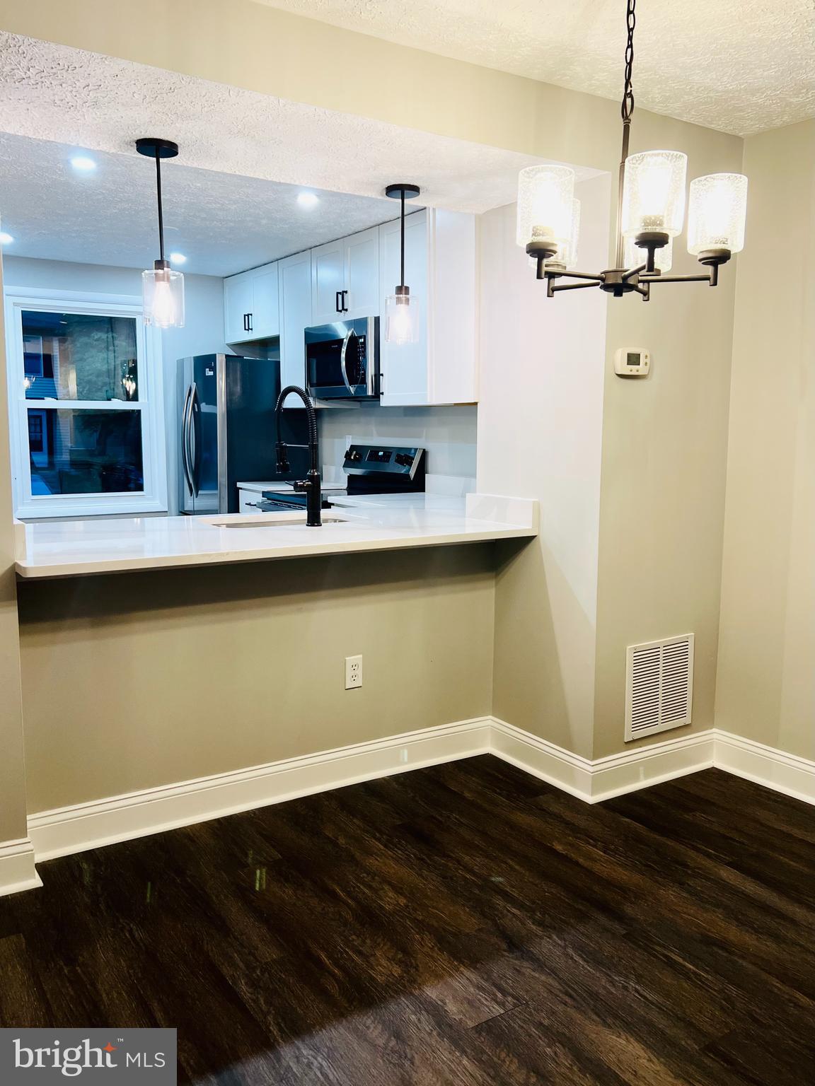 8442 Sugar Creek Lane Springfield, VA 22153 - Photo 5 of 39 a view of a kitchen with wooden floor and a sink