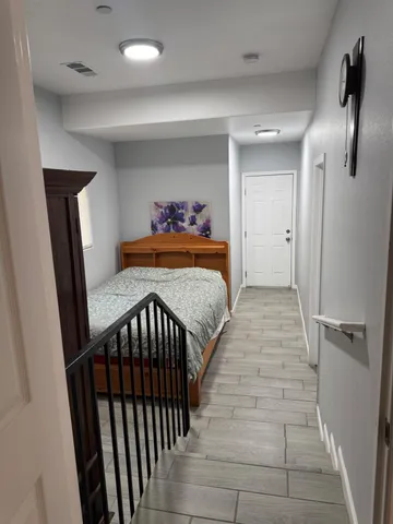 a bedroom with sink and a mirror