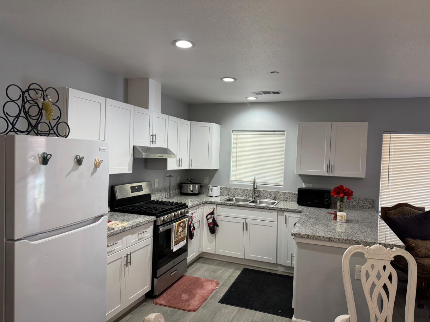 3280 McCall Avenue Selma, CA 93662 - Photo 2 of 56 a kitchen with a refrigerator a white stove top oven a sink and cabinets