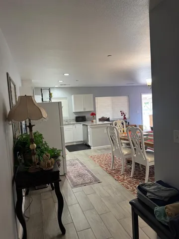 a living room with furniture and a kitchen area