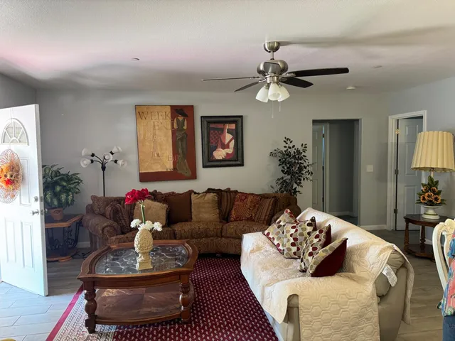 a living room with furniture and a chandelier