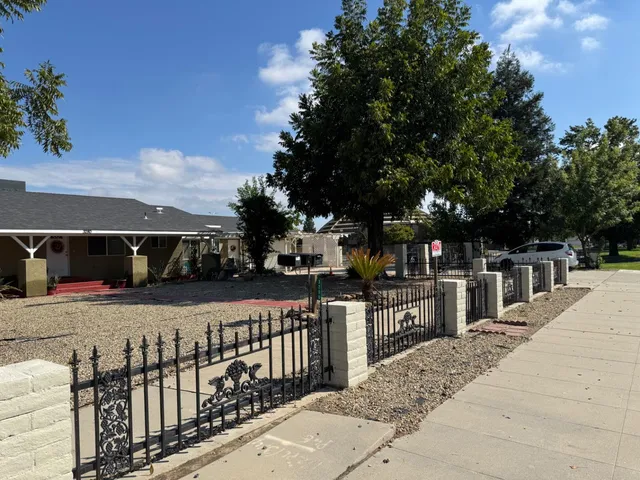 a view of a street with large trees