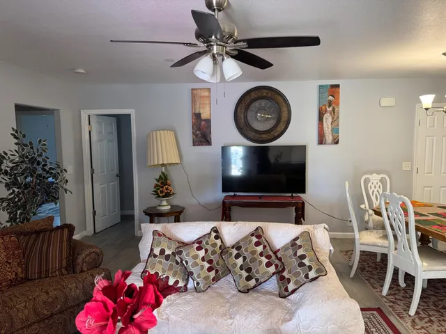 a living room with furniture and a mirror
