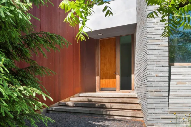 a bathroom with a mirror and a wooden door