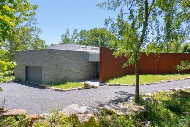 a backyard of a house with a yard and outdoor seating