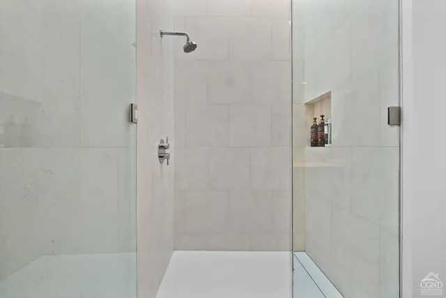 a view of a living room and kitchen with furniture wooden floor and a chandelier