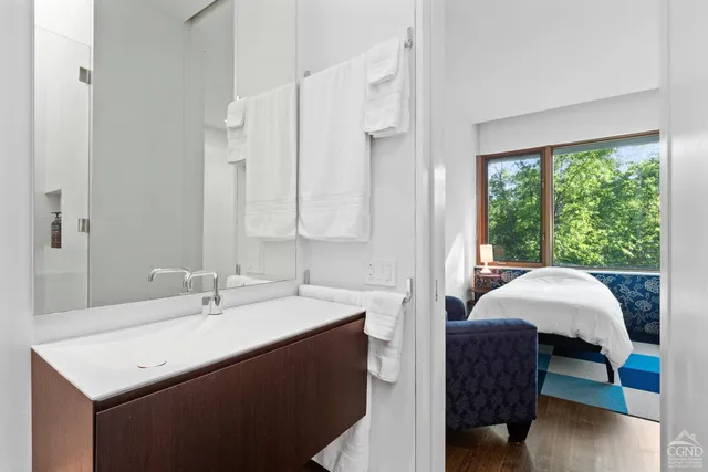 a view of a swimming pool with a yard and large trees