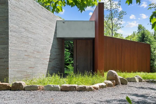 a living room with furniture and large windows