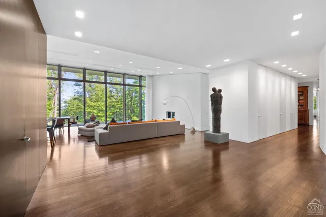 a view of living room with furniture and wooden floor