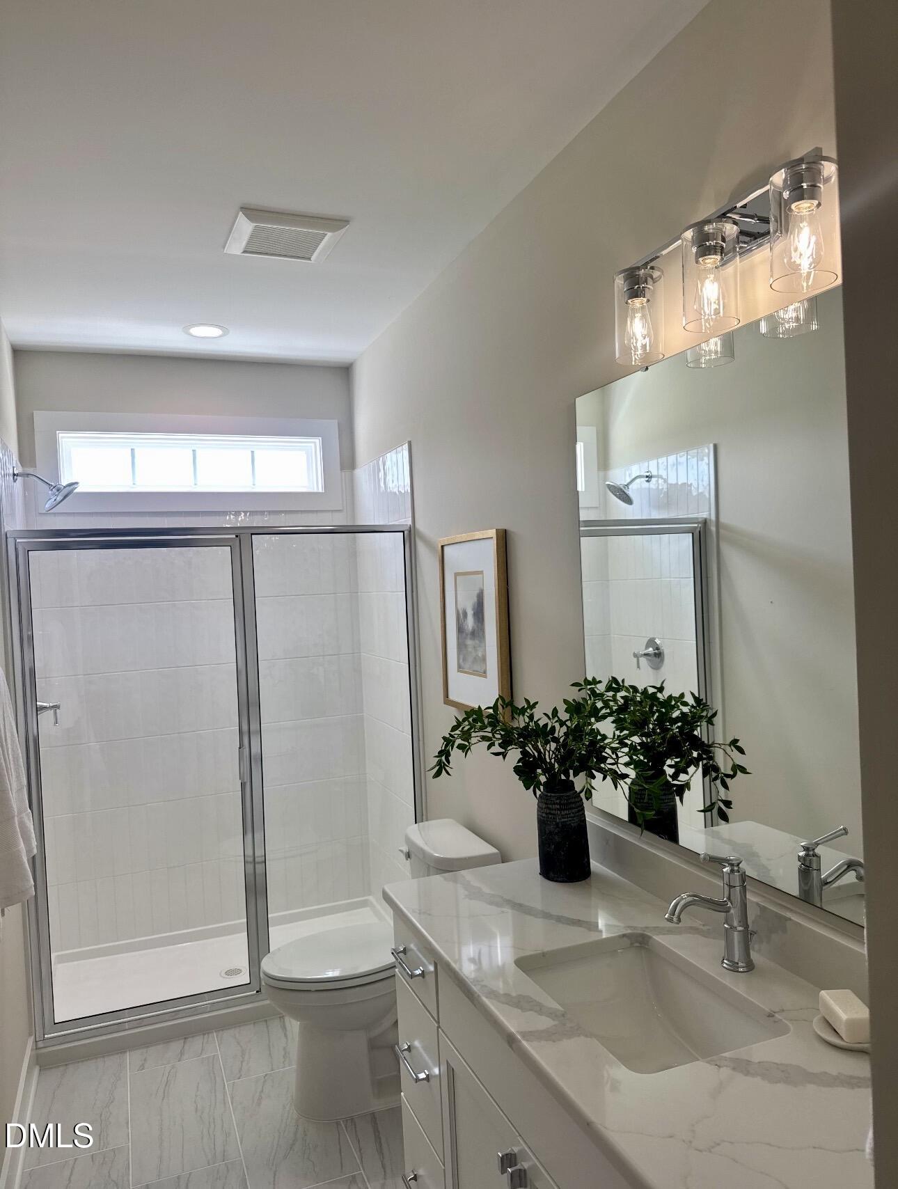 1057 Azalea Garden Circle Raleigh, NC 27603 - Photo 15 of 20 a bathroom with a sink a toilet and mirror