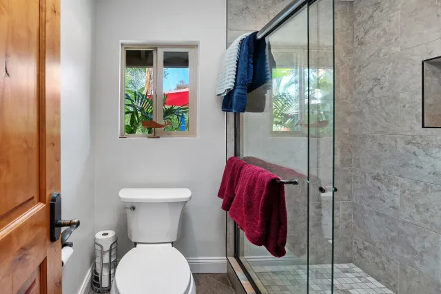 a bathroom with a granite countertop toilet sink and shower
