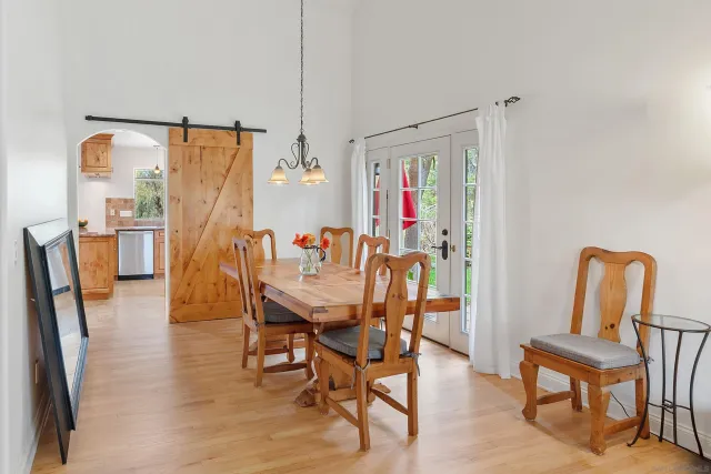 a view of a bedroom with wooden floor and furniture
