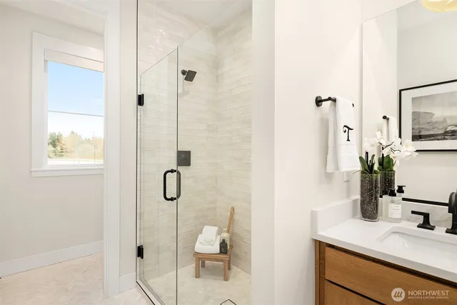 a bathroom with a granite countertop sink a toilet and shower