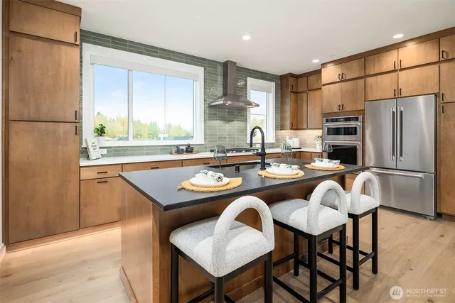 a kitchen with a table chairs refrigerator and cabinets