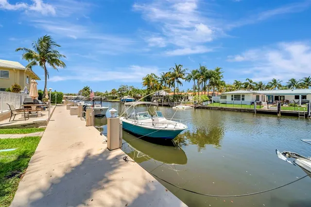a view of a lake with boats and trees in the background