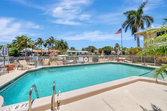 a view of a swimming pool with a garden and trees