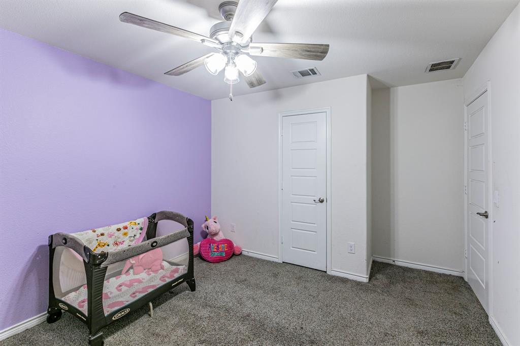 4017 Glastonbury Road McKinney, TX 75071 - Photo 14 of 26 a bedroom with a bed and a chandelier