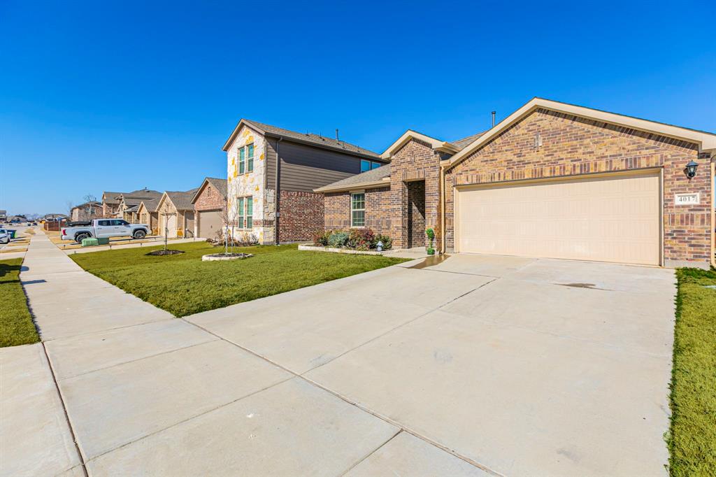 4017 Glastonbury Road McKinney, TX 75071 - Photo 22 of 26 a view of a house with a yard