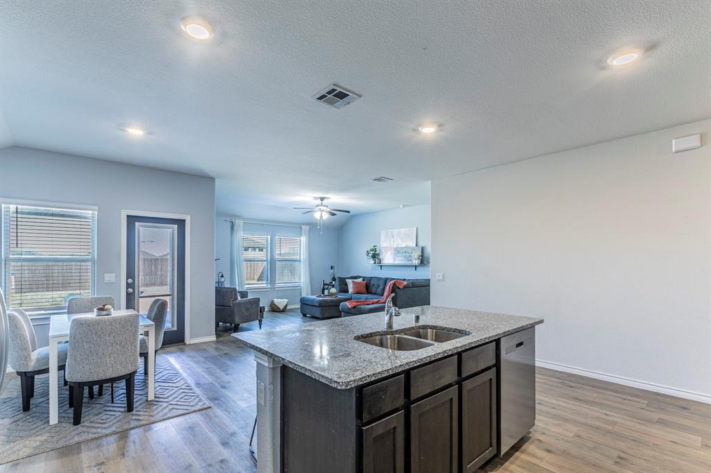 4017 Glastonbury Road McKinney, TX 75071 - Photo 26 of 26 a kitchen with a counter space a sink cabinets and wooden floor