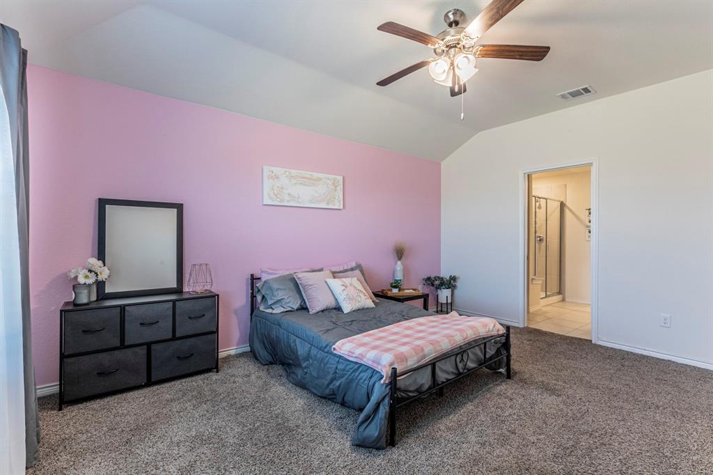 4017 Glastonbury Road McKinney, TX 75071 - Photo 9 of 26 a spacious bedroom with a bed and a chandelier