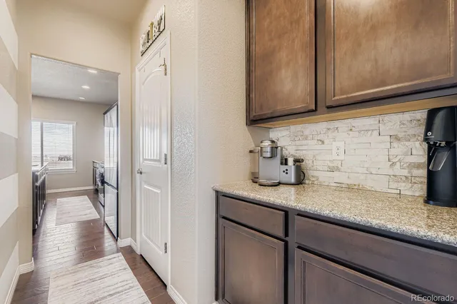 a hallway with sink and mirror