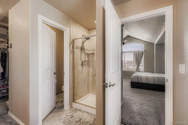 a bedroom with a bed and a mirror