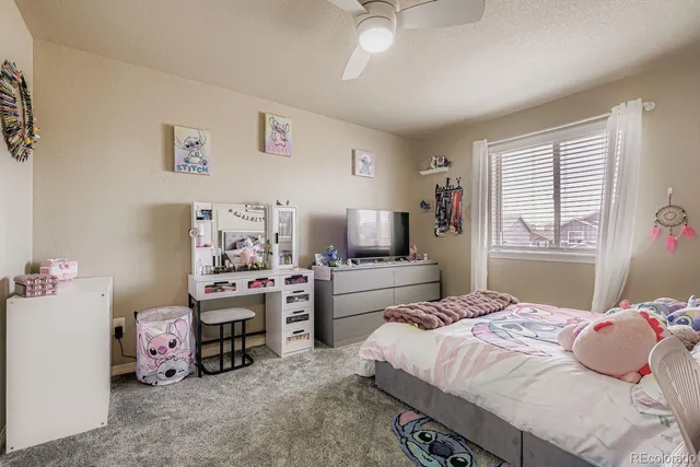 a bedroom with a bed and a desk