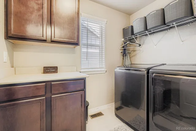 a view of a refrigerator and cabinets