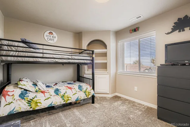 a bedroom with a bed and a tv